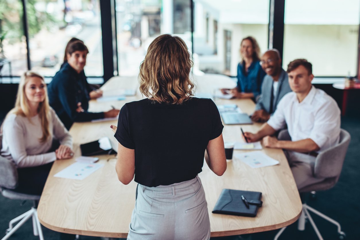 Person Speaking to a Business Team image 1,254 x 836 px