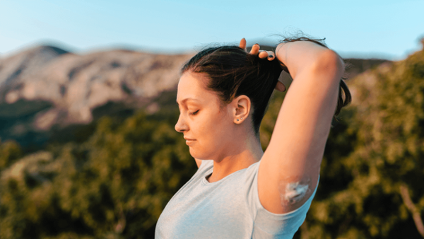 woman exercising with CGM on arm